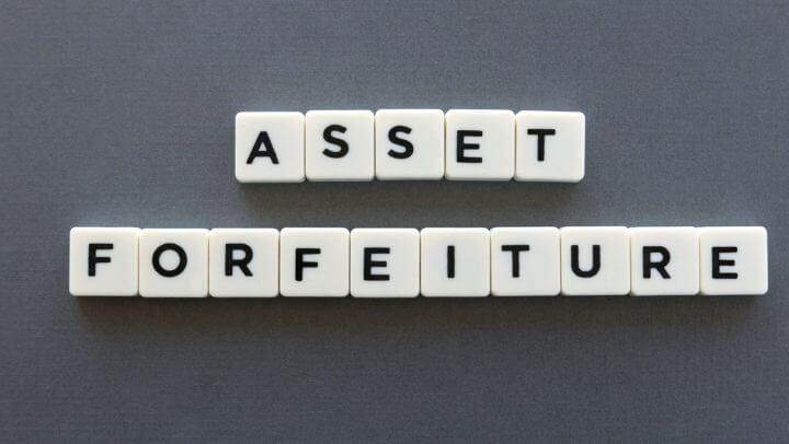 Asset forfeiture word made of square letter word on grey background.