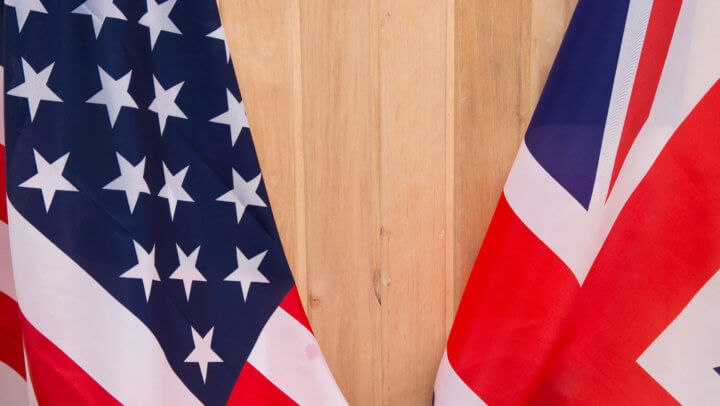 USA flag and UK Flag on wooden background light.