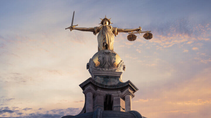 Justice On The Old Bailey, London with a sunset background